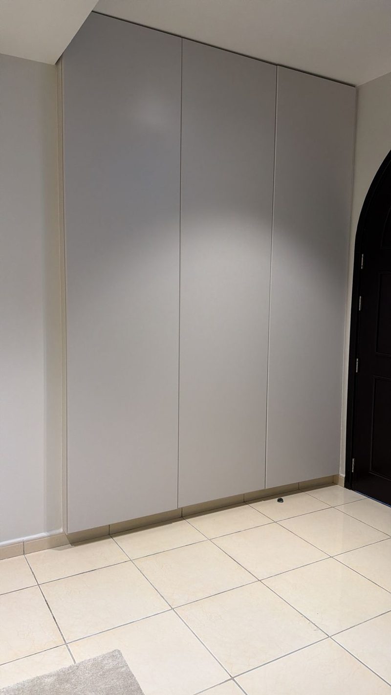 Full-height fitted wardrobe built into an alcove in a villa bedroom — Reef Al Ghadeer, Al Ain