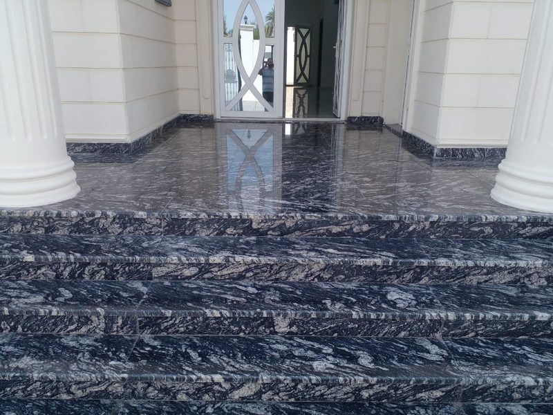 Dark patterned granite entrance steps and threshold at a villa doorway — Reef Al Ghadeer, Al Ain