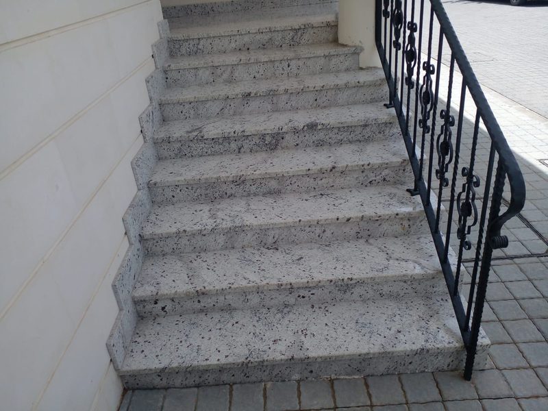 Speckled granite staircase with an iron balustrade in a villa hallway — Reef Al Ghadeer, Al Ain