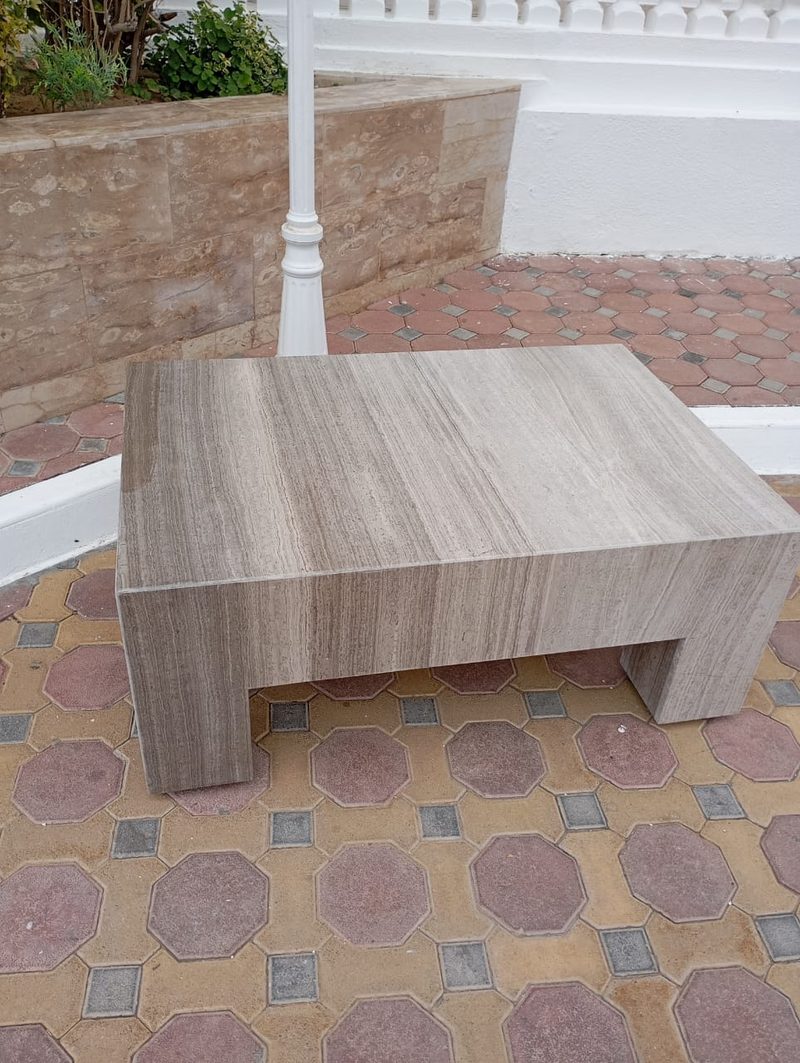 Solid stone coffee table on a patterned courtyard floor — Reef Al Ghadeer, Al Ain