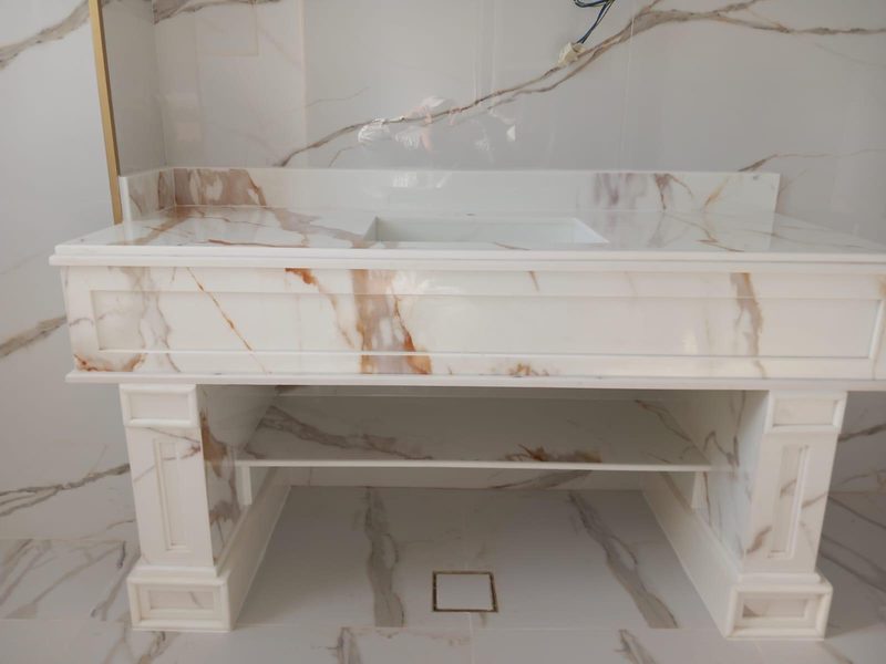 Onyx-veined marble console with a moulded apron and open shelf — Reef Al Ghadeer, Al Ain